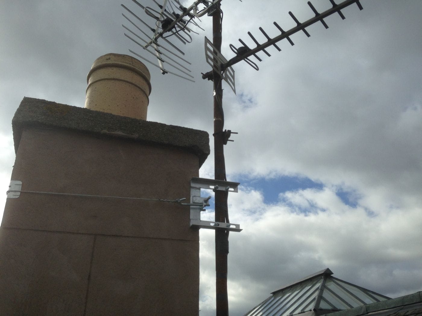New wall brackets and chimney lashing holding an aerial mast secure