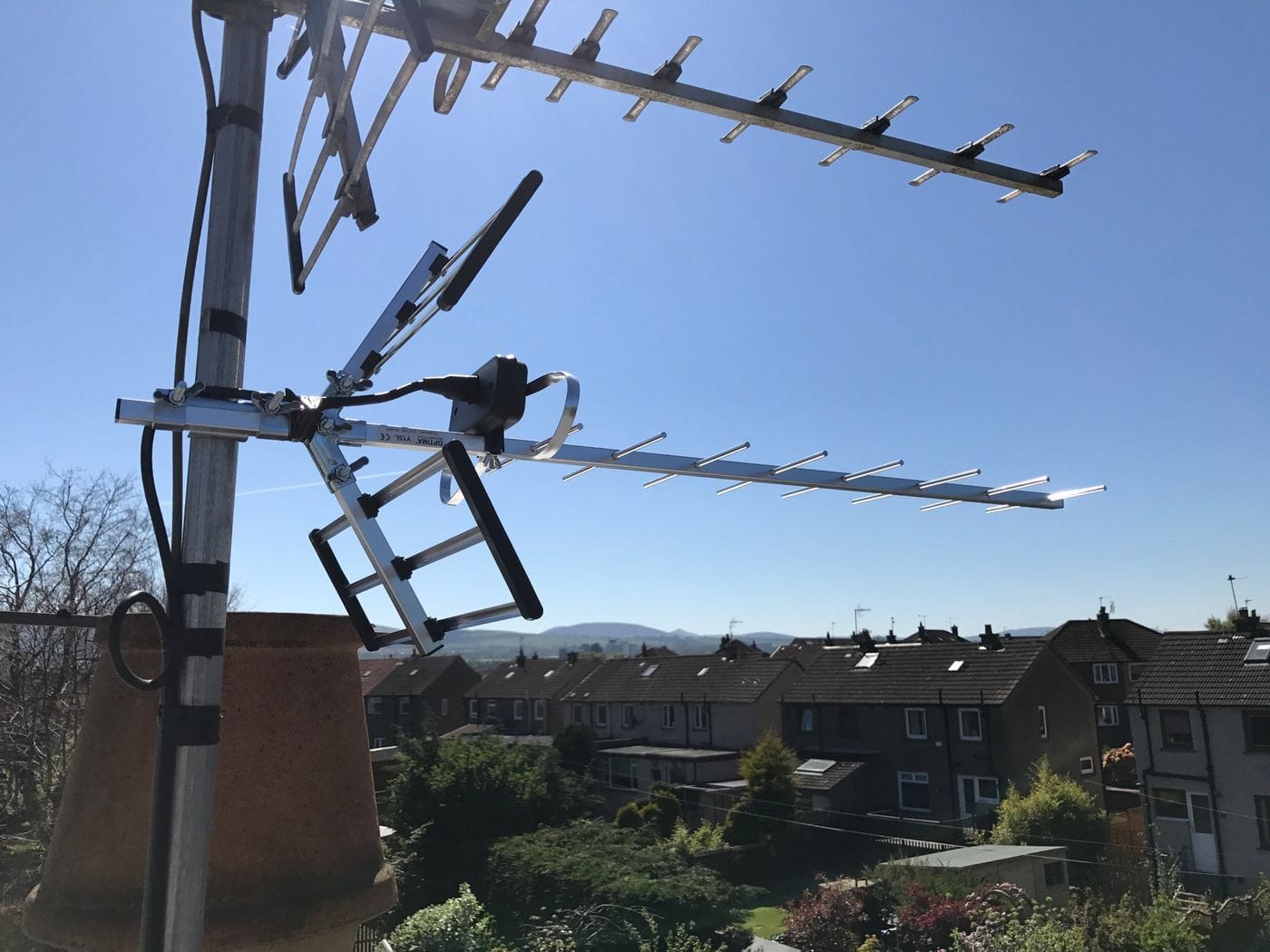 Newly installed TV aerial on a chimney with a view over Edinburgh